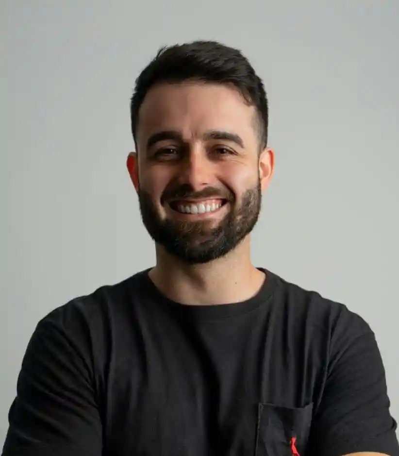 Smiling man wearing a white turban in a friendly setting