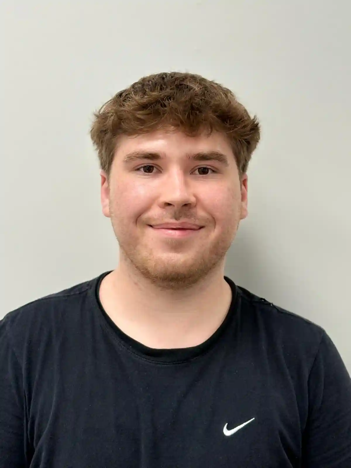 Smiling young entrepreneur sitting in a contemporary office space