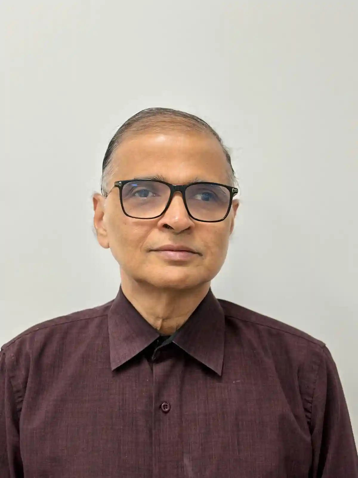 Casual man with a beard wearing a black t-shirt in a relaxed pose